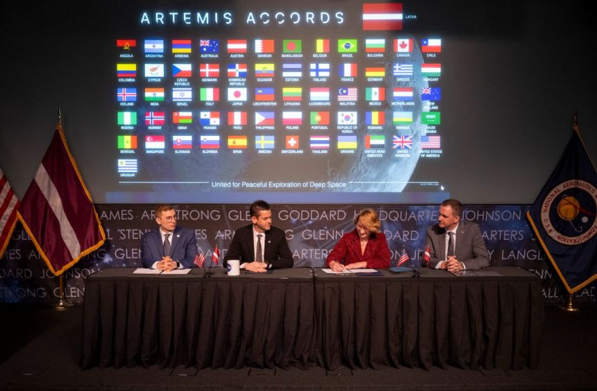 Latvia’s Minister for Education and Science Dace Melbārde, second from right, signs the Artemis Accords, as NASA Administrator Jared Isaacman, second from left, U.S. Under Secretary of State for Economic Affairs Jacob Helberg, left, and chargé d’affaires a.i. at the Embassy of the Republic of Latvia to the United States Jānis Beķeris, right, look on Monday, April 20, 2026, at the Mary W. Jackson NASA Headquarters building in Washington. NASA/Joel Kowsky