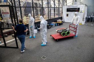 Students from the United States Military Academy (West Point), dressed in safety gear, prepare to enter the mining arena with their robotic miner during NASA’s LUNABOTICS competition on May 24, 2022, at the Center for Space Education near the Kennedy Space Center Visitor Complex in Florida. More than 35 teams from around the U.S. have designed and built remote-controlled robots for the mining competition. NASA/Kim Shiflett
