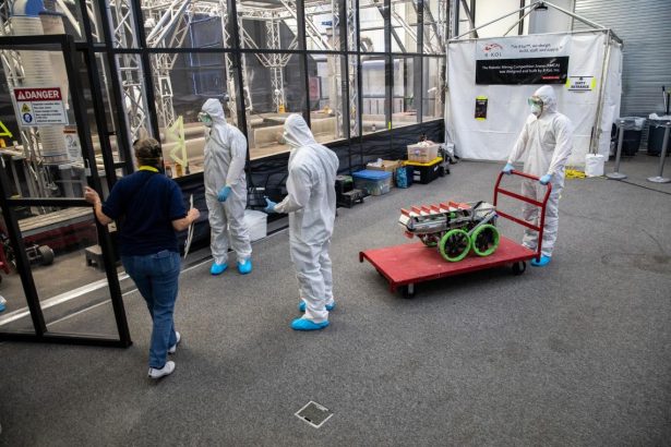 Students from the United States Military Academy (West Point), dressed in safety gear, prepare to enter the mining arena with their robotic miner during NASA’s LUNABOTICS competition on May 24, 2022, at the Center for Space Education near the Kennedy Space Center Visitor Complex in Florida. More than 35 teams from around the U.S. have designed and built remote-controlled robots for the mining competition. NASA/Kim Shiflett